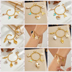 Gold-tone enamel ocean charm bracelet with shell, starfish and sea creature charms