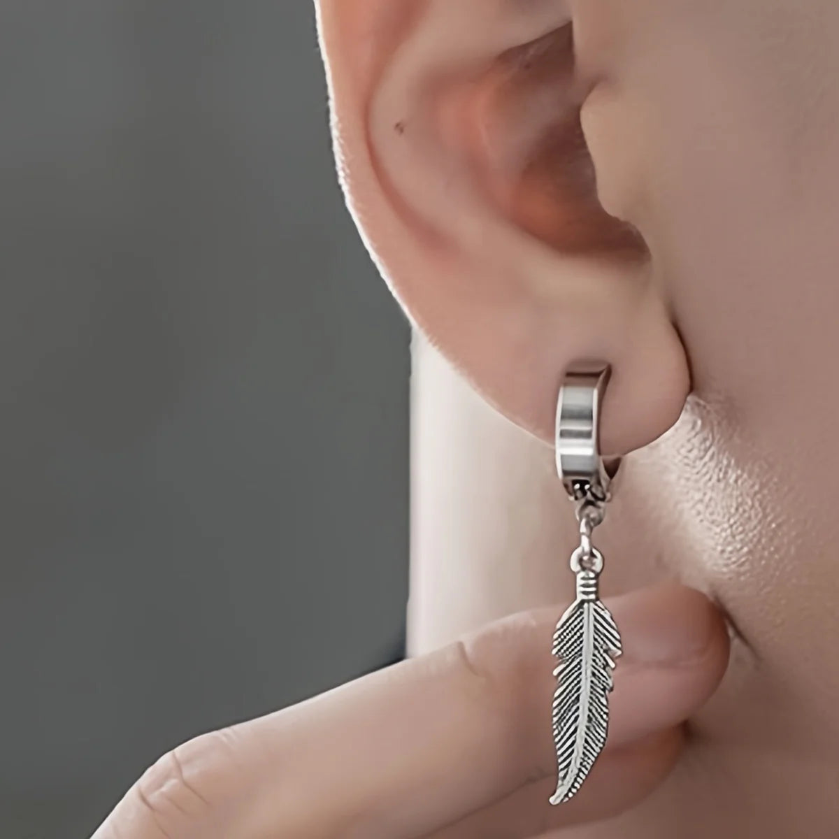 Silver stainless hoop ear clips with dangling feather charms for pierced ears