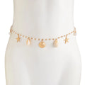 Pearl belly chain on mannequin with starfish and shell charms, gold-tone drops