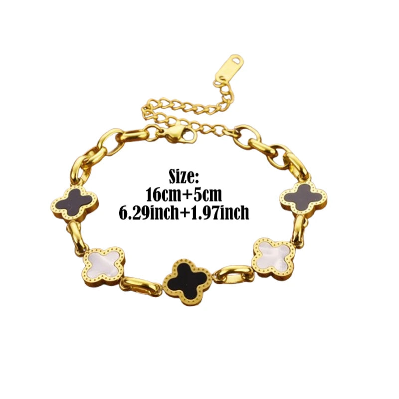 Four-leaf clover charm bracelet with gold-tone chain and alternating white and dark clover charms