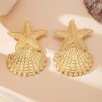 Gold starfish-and-shell dangling earrings, pair view with fan-shaped shell tiers