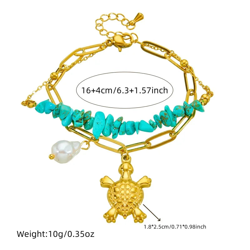 Turquoise beaded double-layer necklace with gold turtle charm and pearl, shown flat