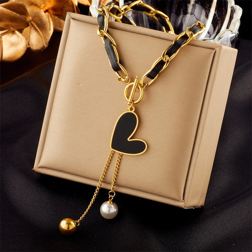 Gold-tone chain necklace with black heart charm and pearl-to-gold ball dangles