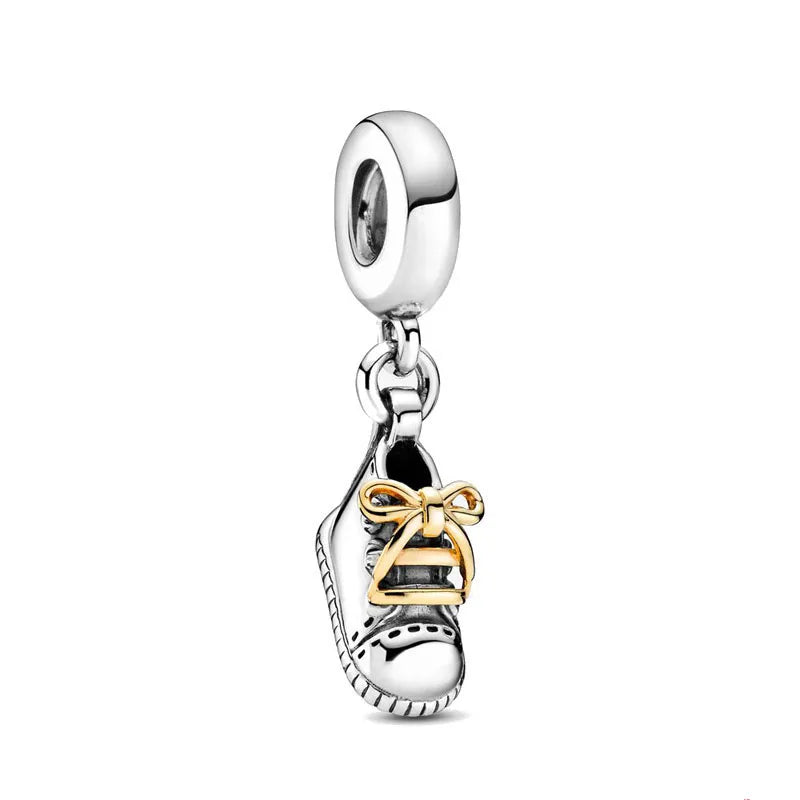 Silver charm bead with dangling bell ornament and ribbon bow accent