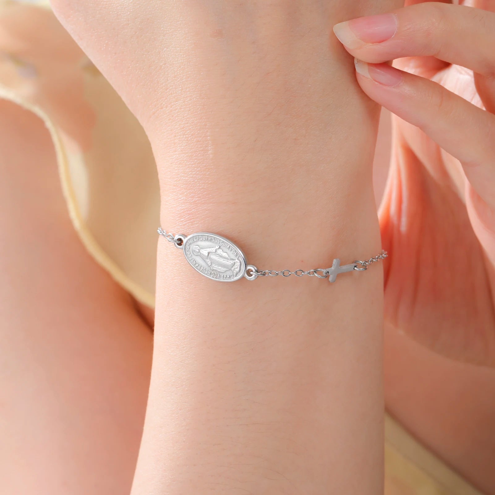 Silver-tone pendant bracelet with oval Virgin Mary medallion and small cross charm details