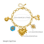 Gold-tone charm necklace featuring heart, blue flower, and round pendant with small tassel