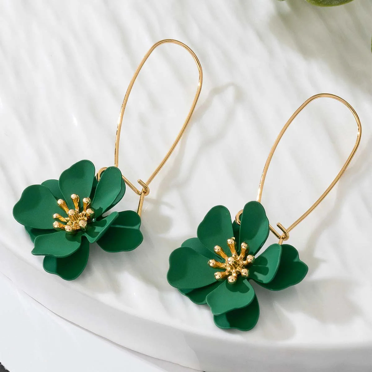 Floral stud earrings with layered green flower petals and gold-tone hooks