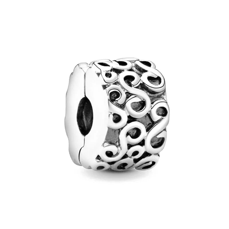 Sterling silver charm bead with swirling filigree texture and recessed oval