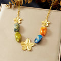 Gold-tone flower pendant necklace with multicolor resin beads on a chain