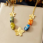 Gold-tone flower pendant necklace with multicolor resin beads on a chain