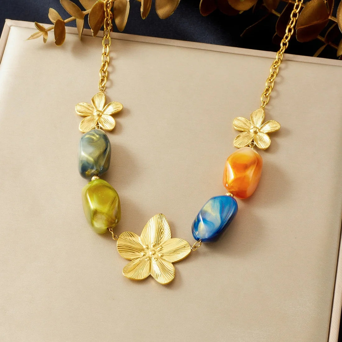 Gold-tone flower pendant necklace with multicolor resin beads on a chain