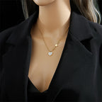 Gold-tone heart and star pendant clavicle chain necklace on a model