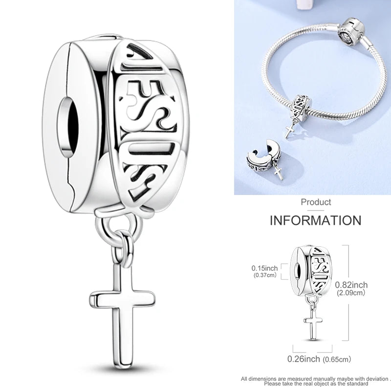 Sterling silver cross charm with decorative cutout pattern and small stone
