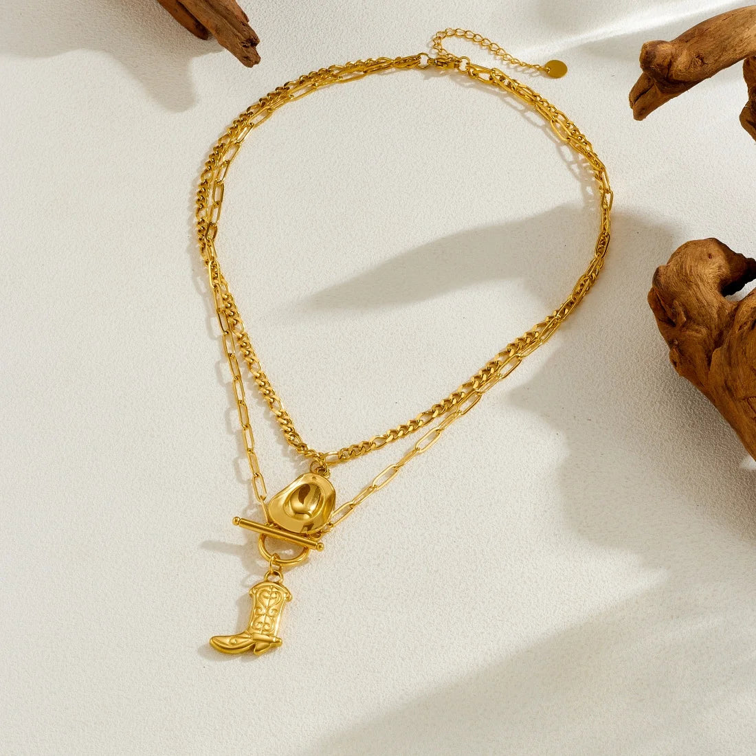 Gold-tone long pendant necklace with cowboy hat and boot charms