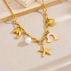 Gold-tone multi-pendant necklace with dolphin, pearl, rainbow cloud, starfish and shell charm