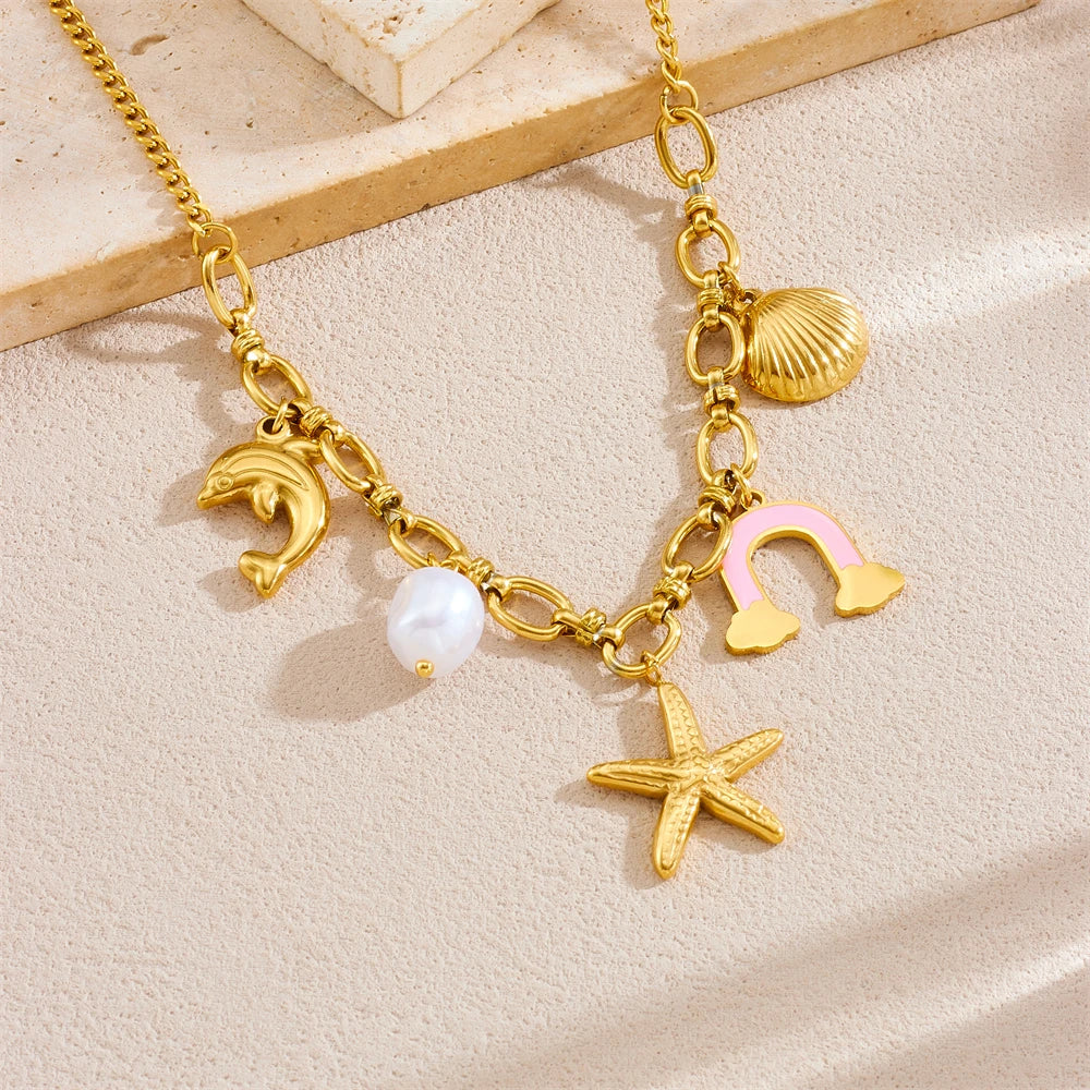 Gold-tone multi-pendant necklace with dolphin, pearl, rainbow cloud, starfish and shell charm