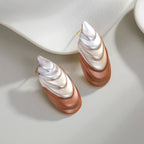 Flower-shaped stud earrings in silver and rose with stacked, curved petal look