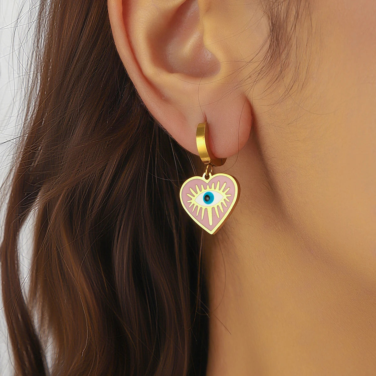 Gold-tone heart dangle earring with pink evil eye enamel and turquoise center