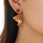 Gold-tone stud earrings with red round cabochon and dangling queen head