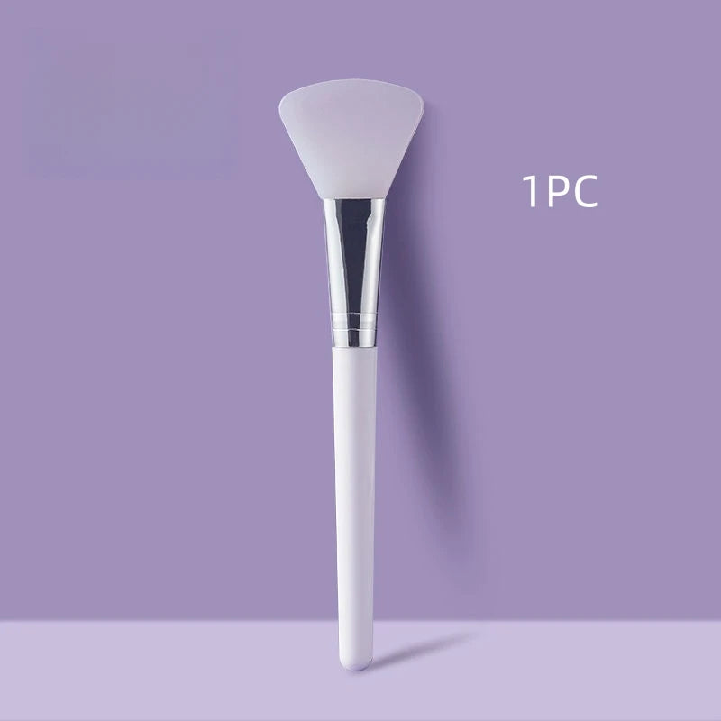 Face mask brush, white silicone head, white handle with chrome collar