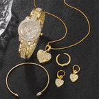 Gold wrist watch with rhinestone bezel and bracelet; pendant necklace, hoop earrings, and rings