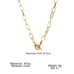 Gold-tone oval link chain collar necklace with oval clasp and small bar charm