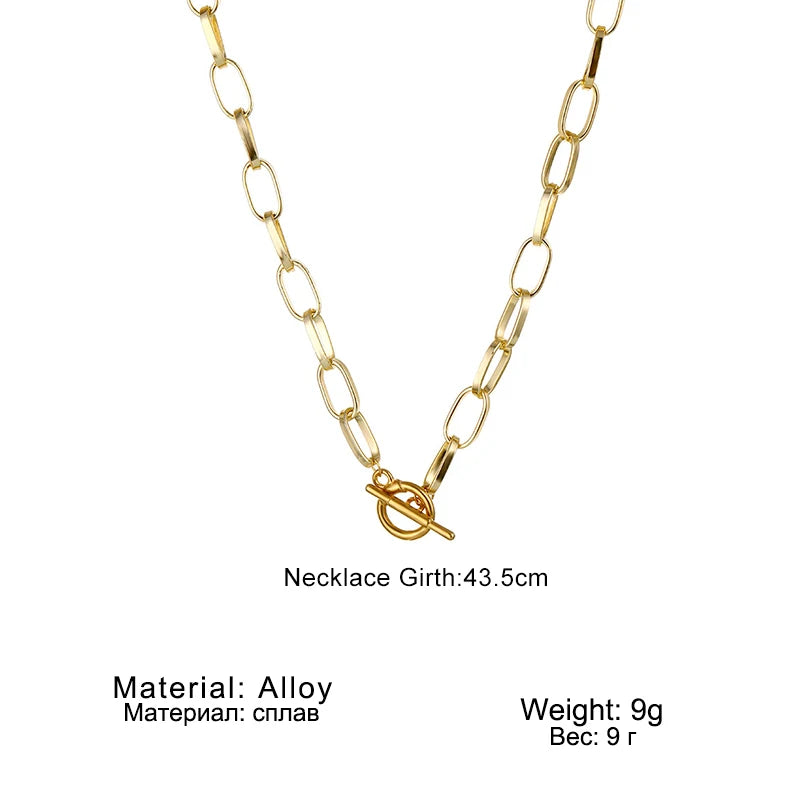 Gold-tone oval link chain collar necklace with oval clasp and small bar charm