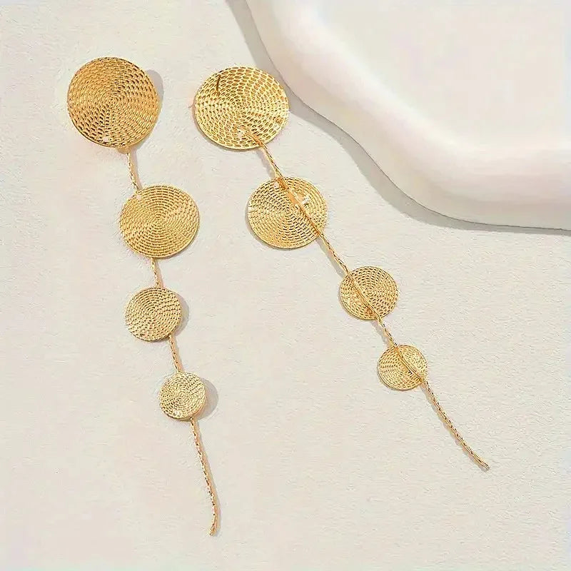 Gold-tone woven disc dangle earrings with four round circles and long thin tail tassels