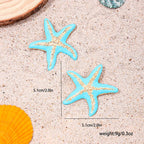Starfish stud earrings with two blue enamel starfish on sand