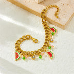 Watermelon enamel charm necklace with gold-tone chain and red-green watermelon charms on white surface