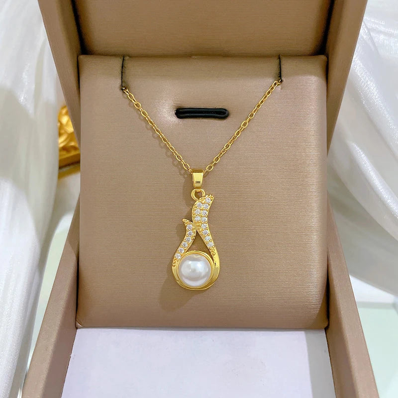 Gold-tone pearl drop pendant necklace in a gift box, chain visible