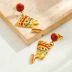 Gold-tone drop earrings featuring queen profile with red cabochon studs and blue/red crown