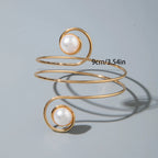 Gold-tone upper arm bracelet with spiral wire and round pearl stone accents