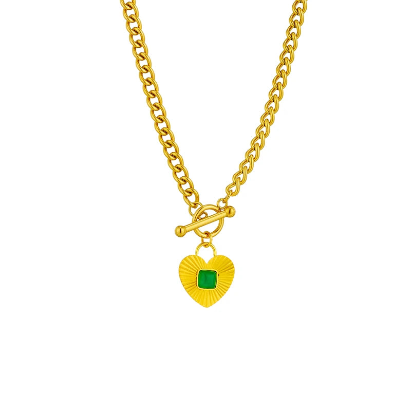 Gold-tone heart charm necklace with green square stone centerpiece on curb chain