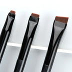 Eyeliner and eyebrow makeup brushes, flat angled heads with brown bristles