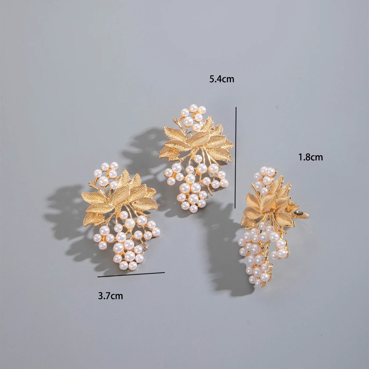 Pearl and gold-tone leaf cluster drop earrings, three-piece display