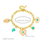 Gold-tone charm bracelet with evil eye, heart pendant, hamsa, and turquoise bead details