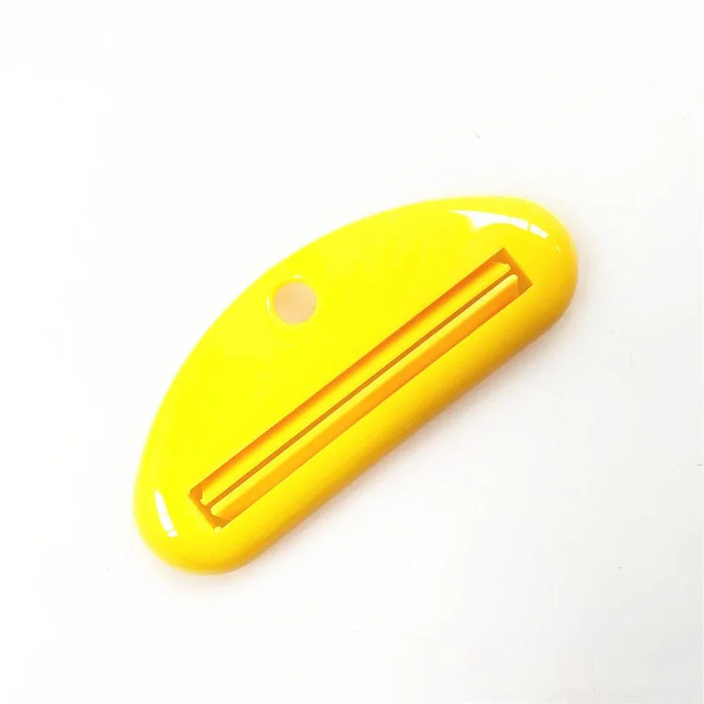 Yellow toothpaste tube squeezer dispenser with long slotted opening and side hole