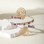 Gold-tone upper arm bracelet set with spiral motif and purple stone bead fringe