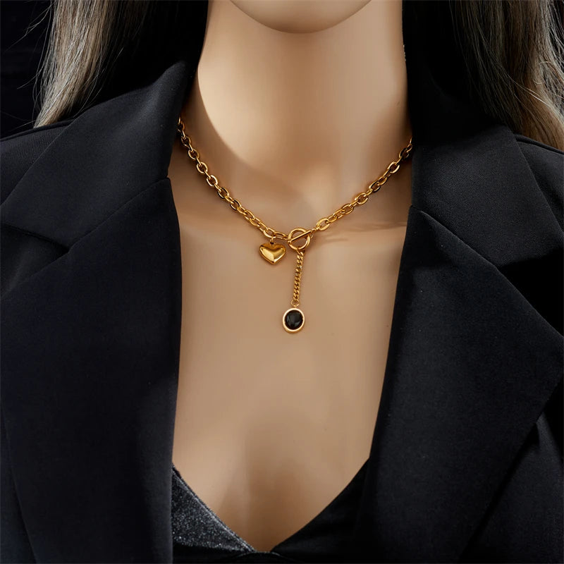 Heart pendant necklace with gold-tone chain, heart charm and round black stone drop