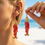 Gold-tone koi charm earrings with red bead tassels, long drop dangles.