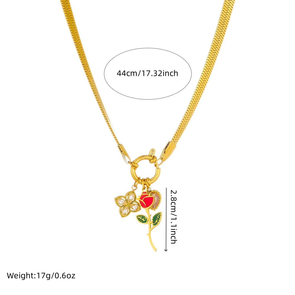 Gold-tone snake chain necklace with rose flower and red heart pendant