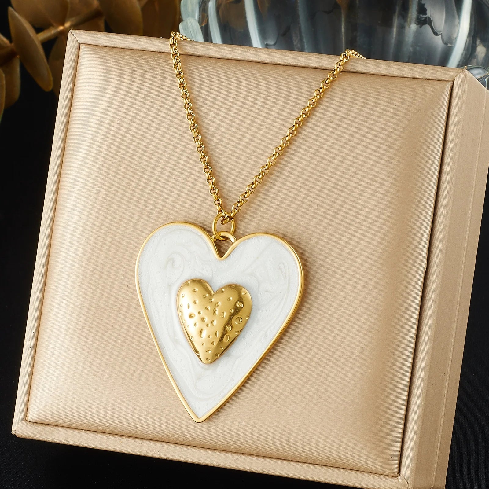 White enamel heart pendant necklace with gold inner heart on gold chain