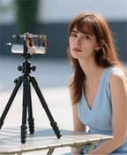 Selfie monitor screen mounted on a tripod with a phone filming