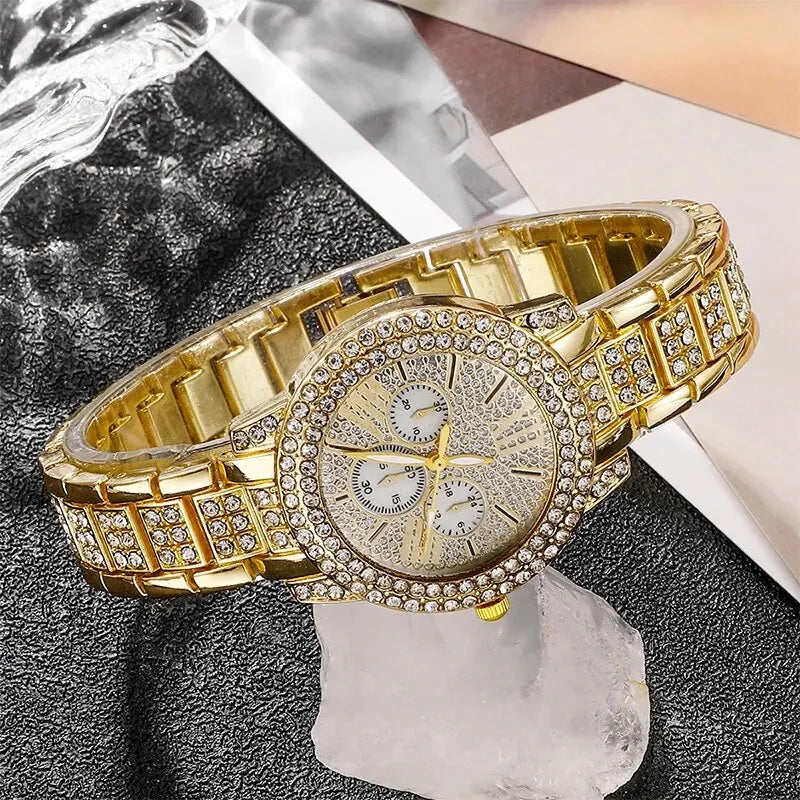 Gold rhinestone wrist watch side view with textured bezel and segmented metal bracelet