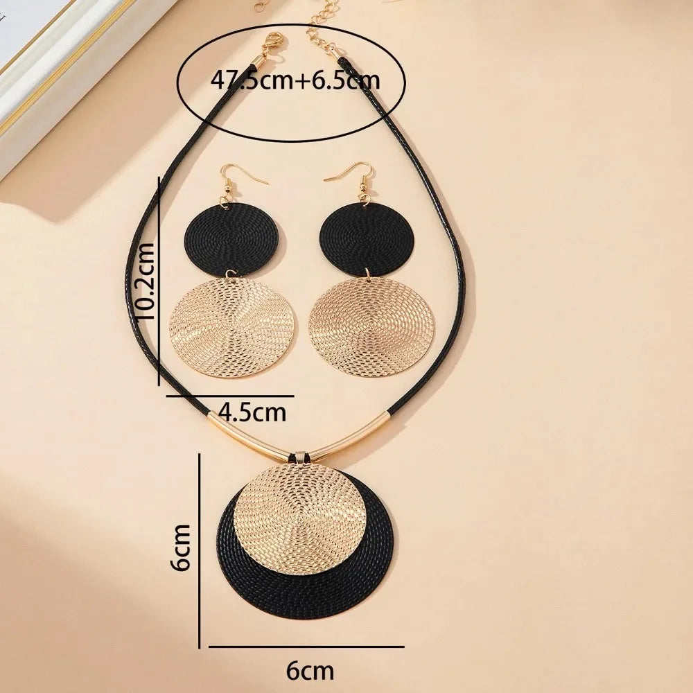 Round statement earrings set with layered black and gold round discs and gold-tone hooks