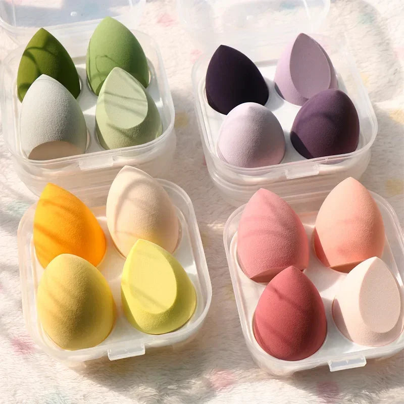 4-piece makeup sponge set with green, dark purple, yellow, and pink teardrop sponges