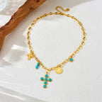 Gold-tone cross pendant necklace with turquoise bead cross and small coin charm