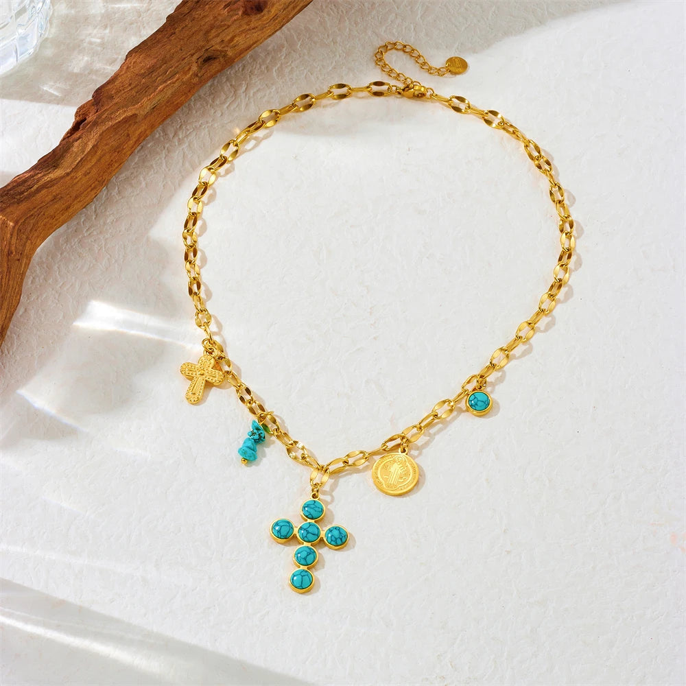 Gold-tone cross pendant necklace with turquoise bead cross and small coin charm