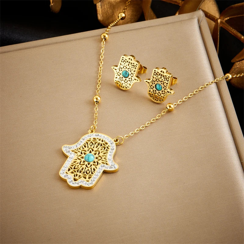Gold-tone hamsa pendant necklace with turquoise stone and matching hamsa stud earrings